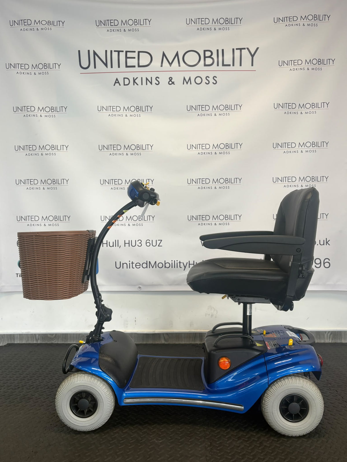 Eden Bootmaster mobility scooter side view with blue body, basket and padded seat