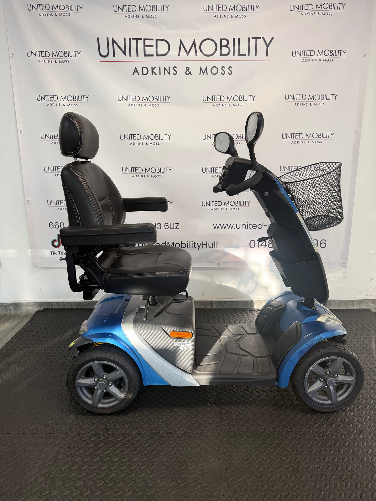 Blue and silver mobility scooter side profile with black seat and armrests