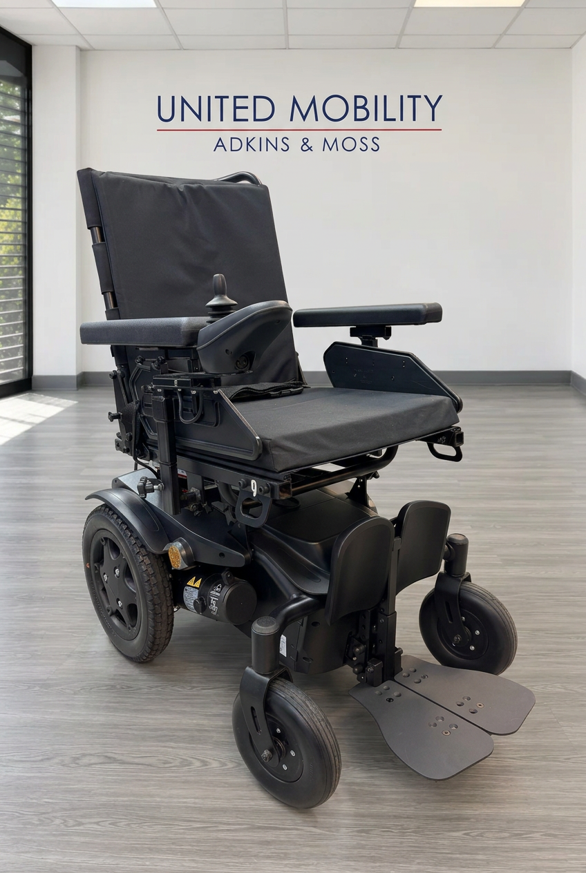 Sunrise Medical Quickie Q100R power chair with black seat, armrests, footplates and large rear wheels