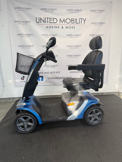 Blue mobility scooter side view with black armrests and headrest