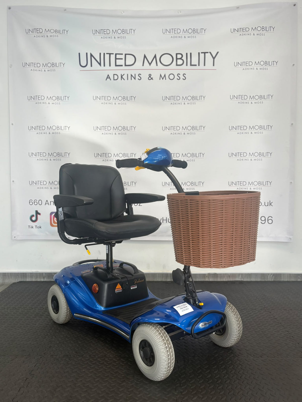 Blue Eden Bootmaster mobility scooter with black seat and brown front basket