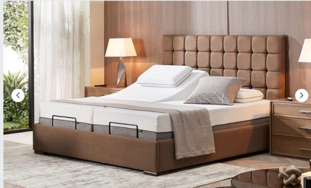 A modern upholstered bed with a quilted headboard, fitted with plush bedding.
