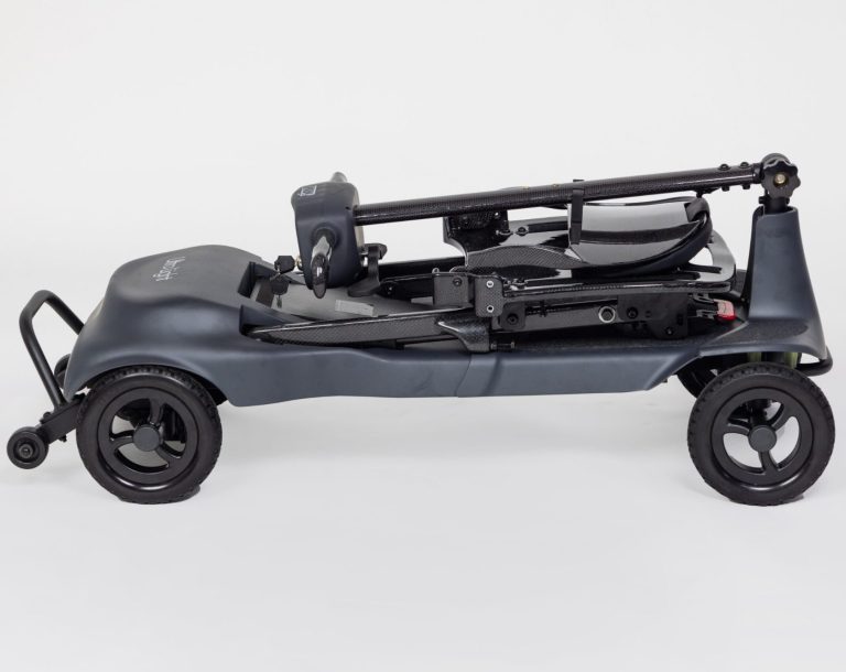 A compact, foldable mobility scooter in dark grey with black wheels.