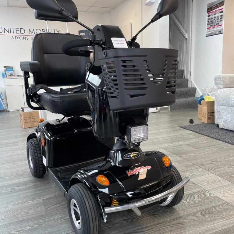 Black mobility scooter parked indoors, featuring a comfortable seat and front basket.