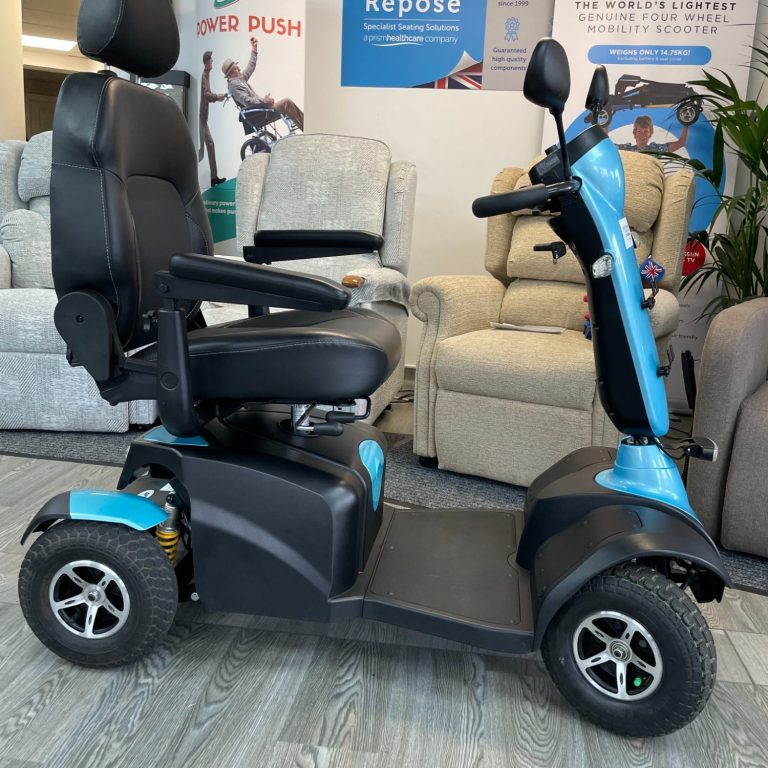 A blue and black mobility scooter parked indoors, with a comfortable seat and armrests.