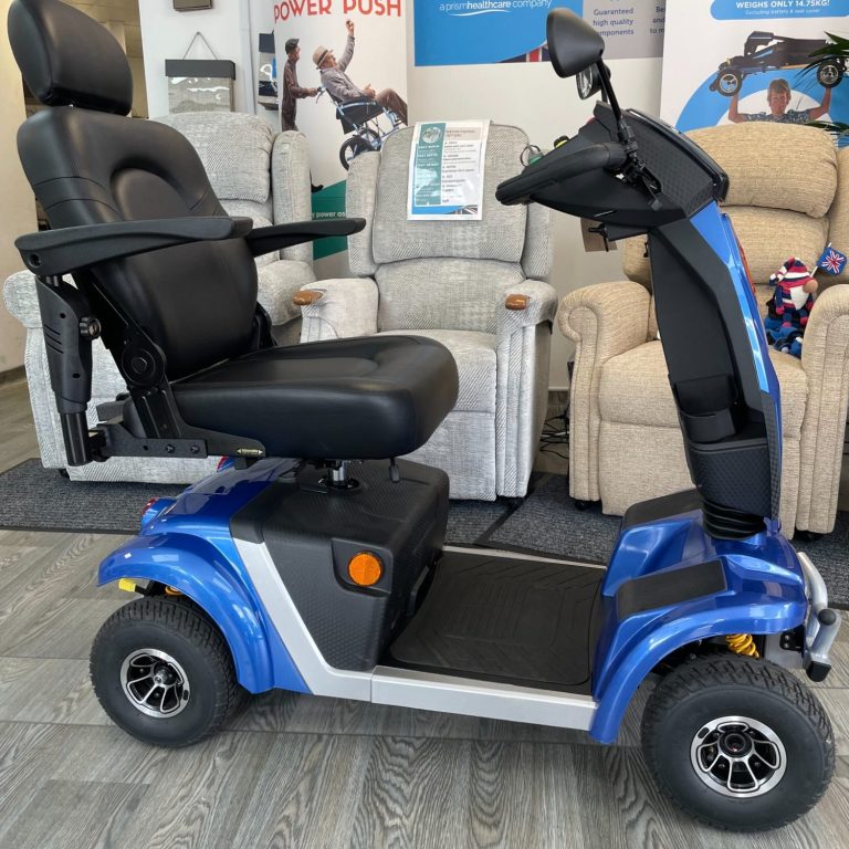 Blue mobility scooter with a comfortable seat and armrests, parked indoors.